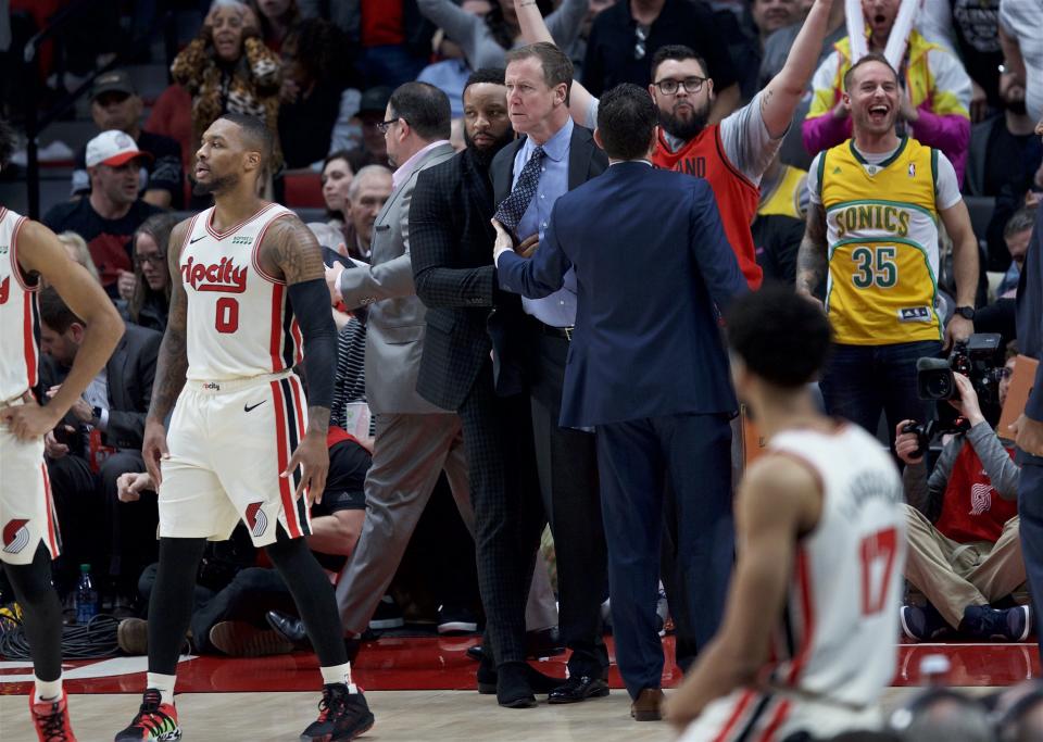 Portland Trail Blazers coach Terry Stotts, center, is held back after being ejected during the second half of the team's NBA basketball game against the Los Angeles Lakers in Portland, Ore., Friday, Dec. 6, 2019. (AP Photo/Craig Mitchelldyer)