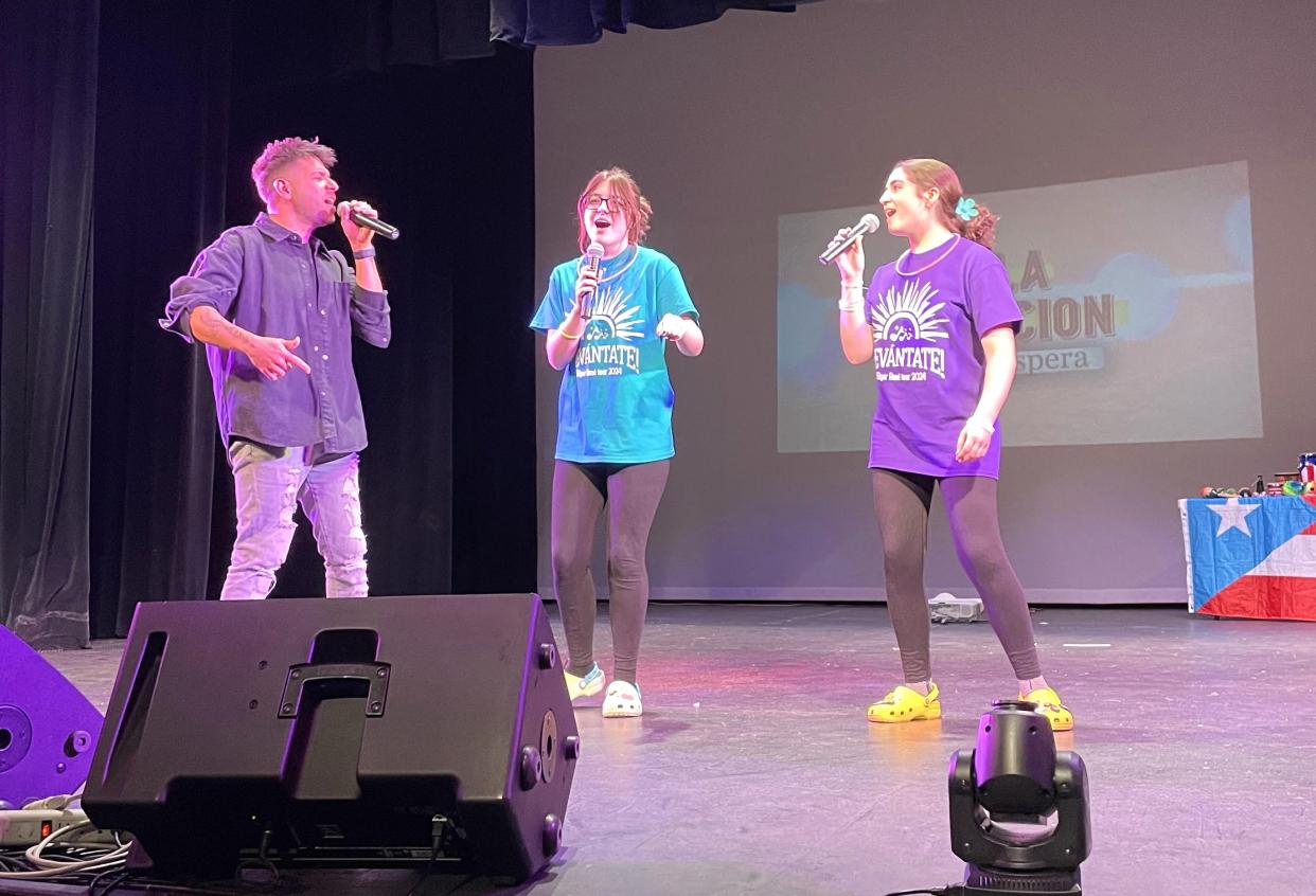 Quincy students Wynter Walker and Saylor Fraley learned and prepared the song "Valientes" so they could sing with Edgar Rene on stage.