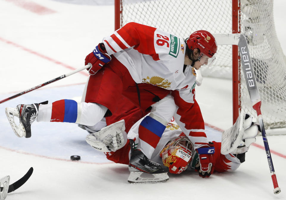 Russia's Alexander Romanov, up, collides with Russia's goaltender Amir Miftakhov during the U20 Ice Hockey Worlds gold medal match between Canada and Russia in Ostrava, Czech Republic, Sunday, Jan. 5, 2020. (AP Photo/Petr David Josek)
