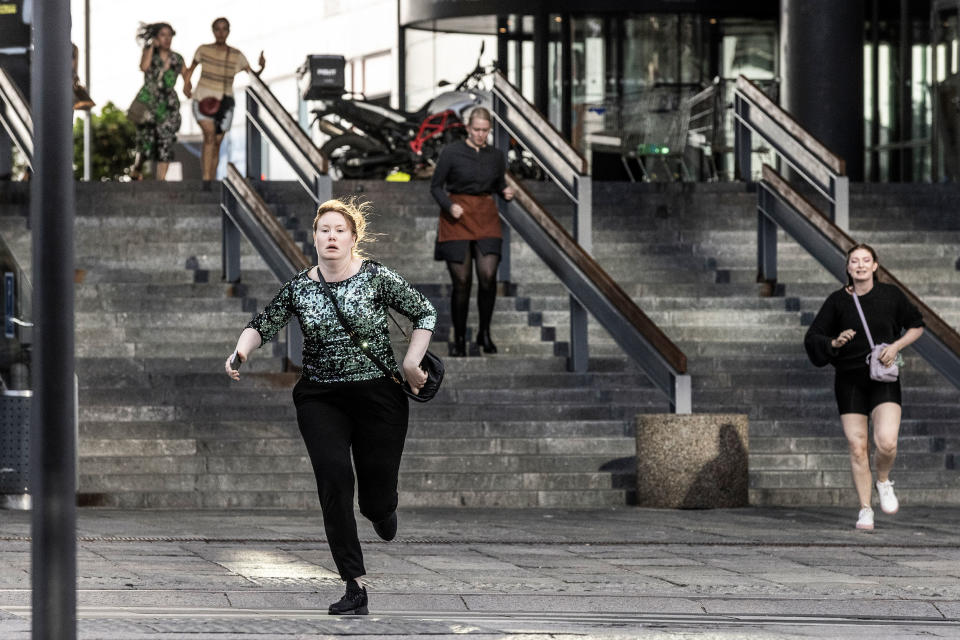 People in front of the Fields shopping center in Copenhagen, Denmark, run after shots were fired. (Ólafur Steinar Rye Gestsson / Sipa / AP)