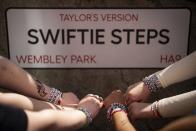 Taylor Swift fans pose with their bracelets infront of the "Swiftie Steps", commissioned by London Mayor Sadiq Khan, before the first London concert of the Eras Tour on Friday, June 21, 2024 in London. (Photo by Scott A Garfitt/Invision/AP)