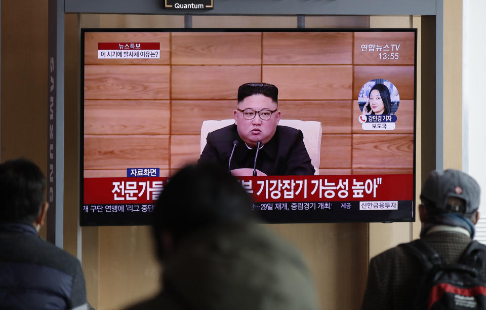 People watch a TV screen showing a news program reporting about North Korea's firing projectiles with a file footage of North Korean leader Kim Jong Un at the Seoul Railway Station in Seoul, South Korea, Monday, March 2, 2020. North Korea fired two unidentified projectiles into its eastern sea on Monday as it begins to resume weapons demonstrations after a months-long hiatus that could have been forced by the coronavirus crisis in Asia. (AP Photo/Lee Jin-man)