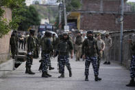 Security officers arrive at the site of an attack in Jammu, India, Friday, April. 22, 2022. Six suspected rebels and an Indian paramilitary officer were killed in two separate armed clashes in Indian-controlled Kashmir, police said on Friday, two days ahead of Prime Minister Narendra Modi's visit to the disputed region.(AP Photo/Channi Anand)