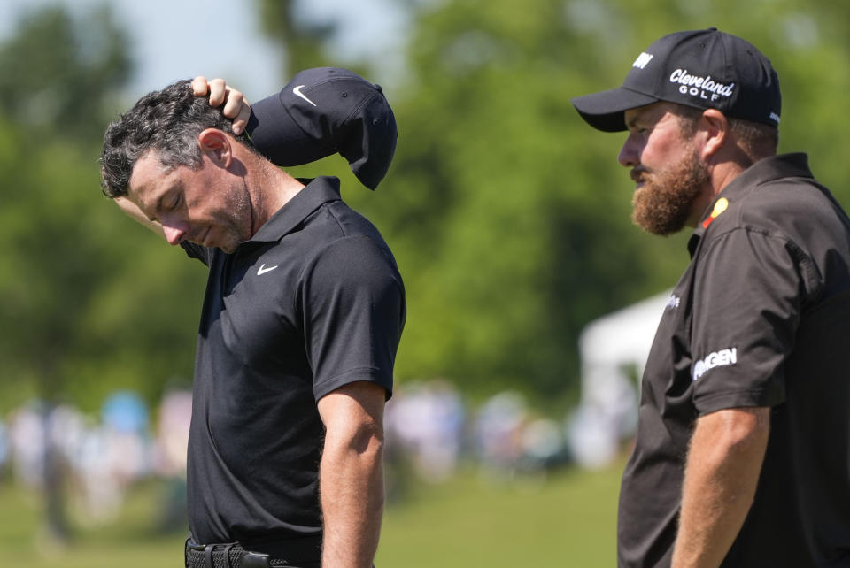 Rory McIlroy, of Northern Ireland, waits his turn on the 18th green with his teammate Shane Lowry, of Ireland, right, during the second round of the PGA Zurich Classic golf tournament at TPC Louisiana in Avondale, La., Friday, April 26, 2024. (AP Photo/Gerald Herbert)