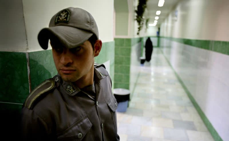 FILE PHOTO: A prison guard stands along a corridor in Tehran's Evin prison June 13, 2006. Iranian police detaine..