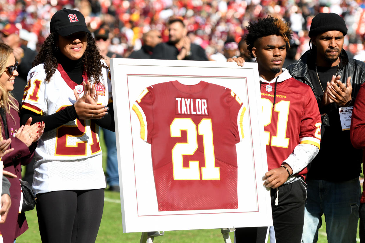 LANDOVER, MARYLAND - OCTOBER 17: Family and friends of Sean Taylor stand during the retirement ceremony of Taylor's jersey at FedExField on October 17, 2021 in Landover, Maryland. (Photo by Mitchell Layton/Getty Images)