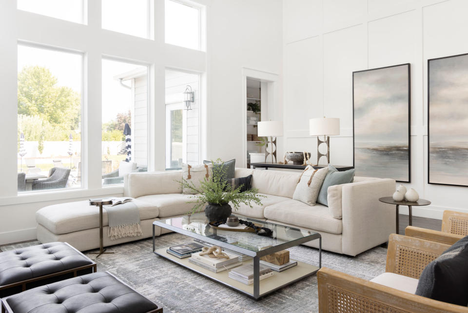 A neutral living room with large wall art