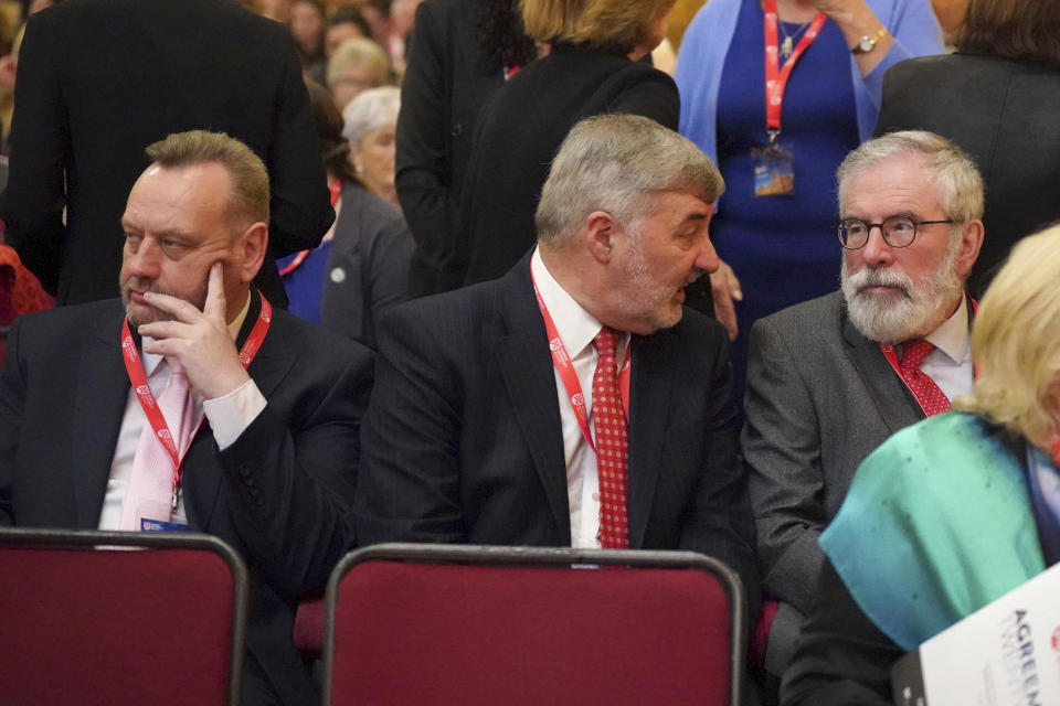 From left, Gary McMichael, former leader of the Ulster Democratic Party, John Alderdice, British member of the House of Lords, and former Sinn Fein president Gerry Adams, share a word on the first day of a three-day international conference at Queen's University Belfast to mark the 25th anniversary of the Good Friday Agreement, in Belfast, Northern Ireland, Monday, April 17, 2023. Former U.S. President Bill Clinton and past leaders of the U.K. and Ireland are gathering in Belfast on Monday, 25 years after their charm, clout and determination helped Northern Ireland strike a historic peace accord. (Niall Carson/PA via AP)