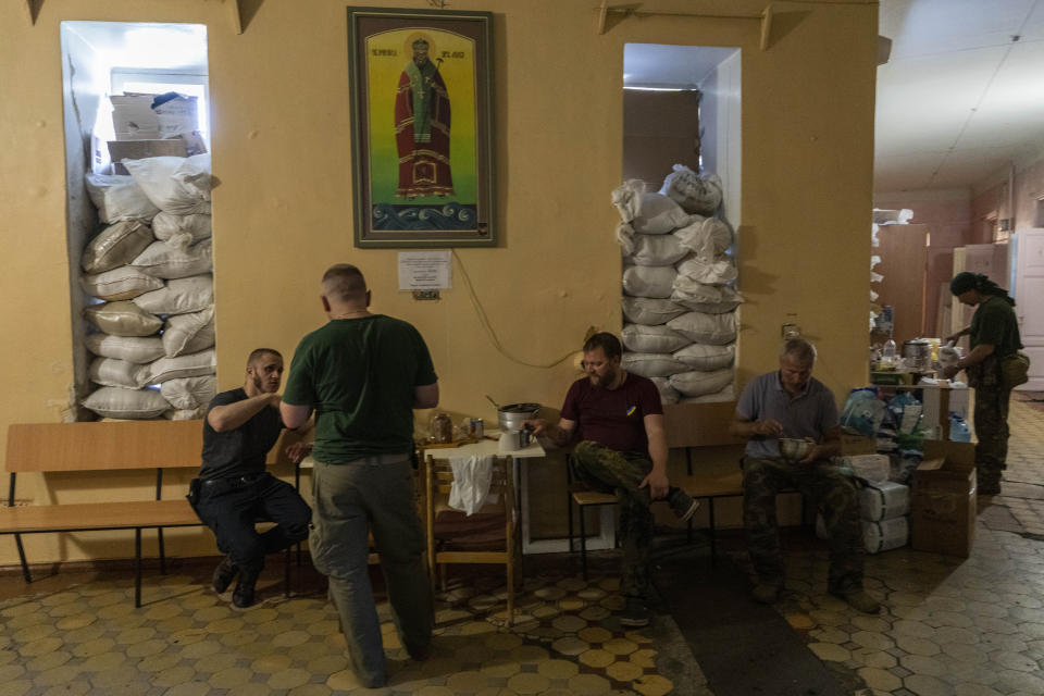 Members of a medical rescue team gather inside their temporary base in the Donetsk oblast region, eastern Ukraine, Saturday, June 4, 2022. (AP Photo/Bernat Armangue)