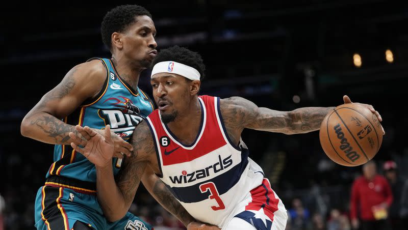 Washington Wizards guard Bradley Beal (3) drives around Detroit Pistons guard Rodney McGruder during the first half of an NBA basketball game, March 14, 2023, in Washington. 