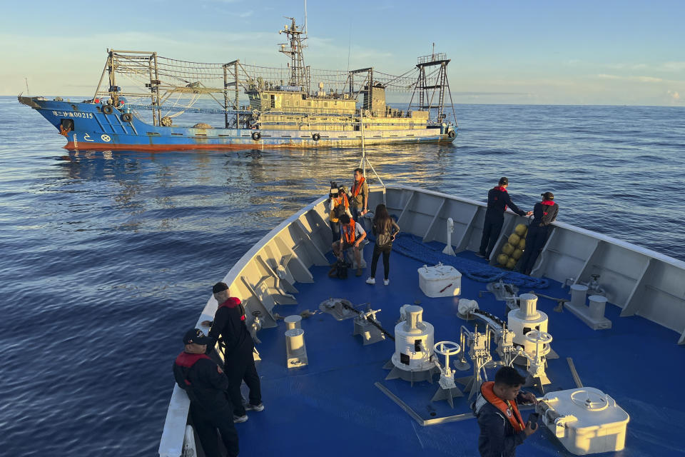 A suspected Chinese militia ship blocks the Philippine coast guard ship BRP Cabra as they approach Second Thomas Shoal, locally known as Ayungin Shoal, during a resupply mission at the disputed South China Sea on Friday Nov. 10, 2023. (AP Photo/Jim Gomez)