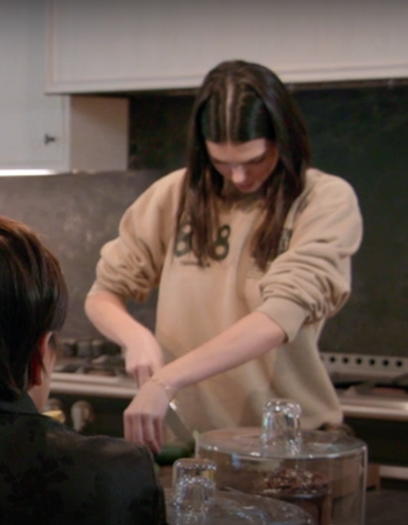 Kendall cutting up a cucumber