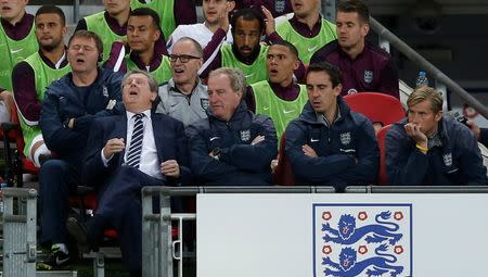 Football - England v Estonia - UEFA Euro 2016 Qualifying Group E - Wembley Stadium, London, England - 9/10/15 England's manager Roy Hodgson, assistant manager Ray Lewington, coach Gary Neville and goalkeeping coach Dave Watson look dejected as the England substitutes look on Action Images via Reuters / Carl Recine