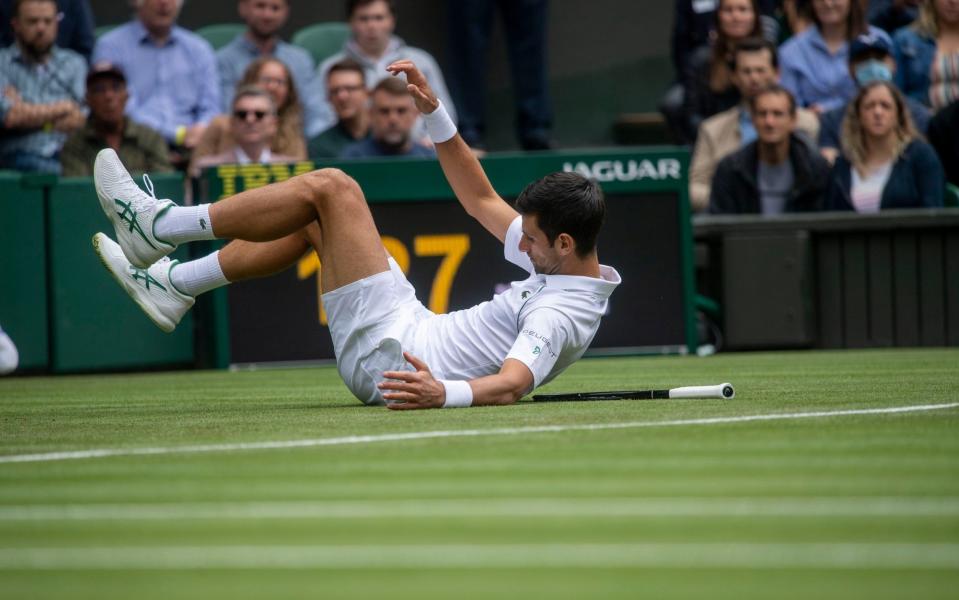 Novak Djokovic falls on Centre Court - PAUL GROVER