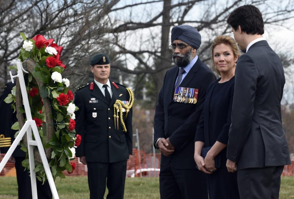 Prime Minister Justin Trudeau, his wife Sophie Gregoire-Turdeau, and Canada’s Defense Minister Harjit Sajjan, pause after laying a wreath at the Canadian Cross of Sacrifice at Arlington National Cemetery in Arlington, Va., Friday, March 11, 2016. (AP Photo/Susan Walsh)