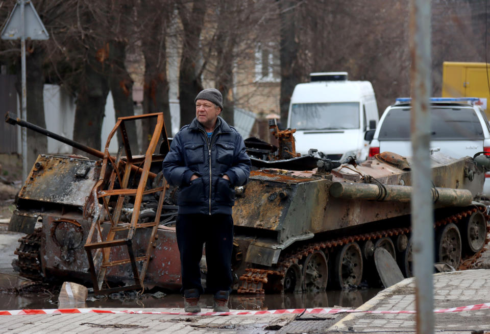 BUCHA, UKRAINE - APRIL 5, 2022 - A man stands in Vokzalna Street following the liberation of the city from Russian invaders, Bucha, Kyiv Region, northern Ukraine. (Photo credit should read Anatolii Siryk/ Ukrinform/Future Publishing via Getty Images)