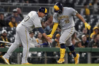 Milwaukee Brewers' Gary Sanchez, right, celebrates with third base coach Jason Lane as he runs the bases after hitting a home run during the eighth inning of the team's baseball game against the Pittsburgh Pirates on Tuesday, April 23, 2024, in Pittsburgh. (AP Photo/Matt Freed)