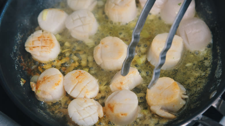 pale scallops in crowded pan