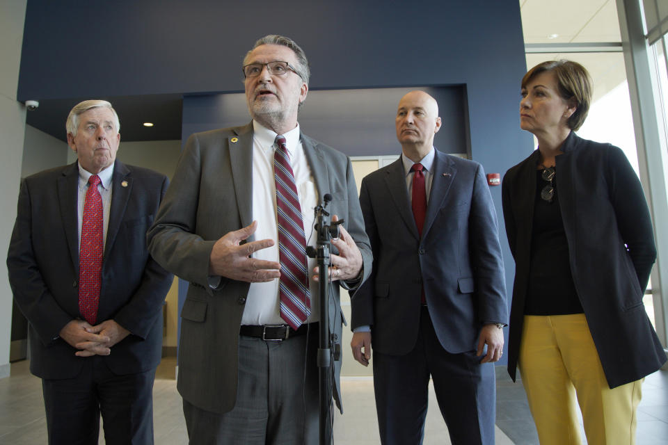 Iowa Gov. Kim Reynolds, right, Nebraska Gov. Pete Ricketts, second right, Missouri Gov. Mike Parson, left, and Kansas Lt. Gov. Lynn Rogers, second left, face reporters following a meeting in Council Bluffs, Iowa, Friday, April 26, 2019, with officials from the U.S. Army Corps of Engineers and the Federal Emergency Management Agency to discuss the aftermath of the recent flooding along the Missouri River. (AP Photo/Nati Harnik)