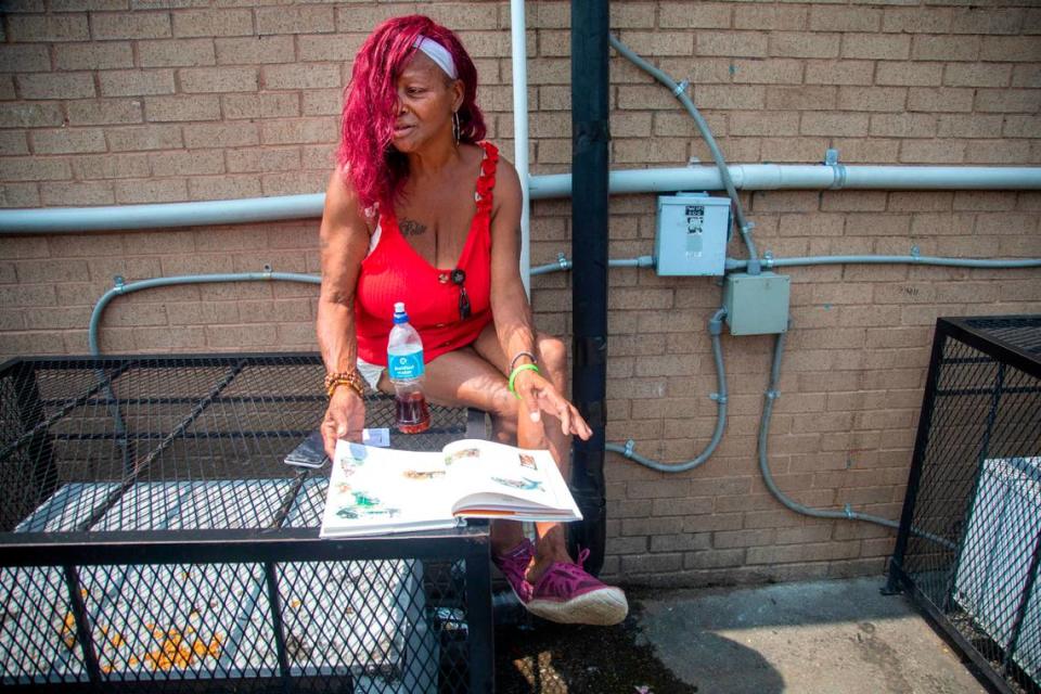 Lottie Shelton, a grandmother of 10, sits in an alley way near the Wake Inn in Raleigh where she often stays in June 2023. Eleven people have been shot at the hotel since January 2020, including one person who died.