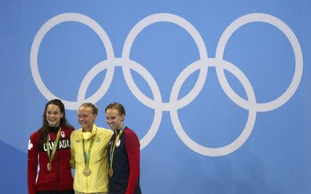 2016 Rio Olympics - Swimming - Victory Ceremony - Women's 100m Butterfly Victory Ceremony - Olympic Aquatics Stadium - Rio de Janeiro, Brazil - 07/08/2016. Gold medallist Sarah Sjostrom (SWE) of Sweden, silver medallist Penelope Oleksiak (CAN) of Canada and bronz medallist Dana Vollmer (USA) of USA pose with their medals. REUTERS/Marcos Brindicci