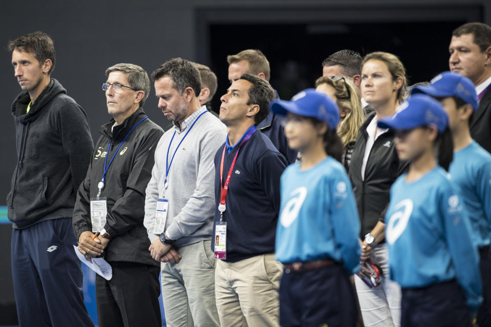 <p>People stand in silence in memory of the victims of the Las Vegas shooting at a court on day four of 2017 China Open on October 3, 2017 in Beijing, China. (Photo: VCG/VCG via Getty Images) </p>