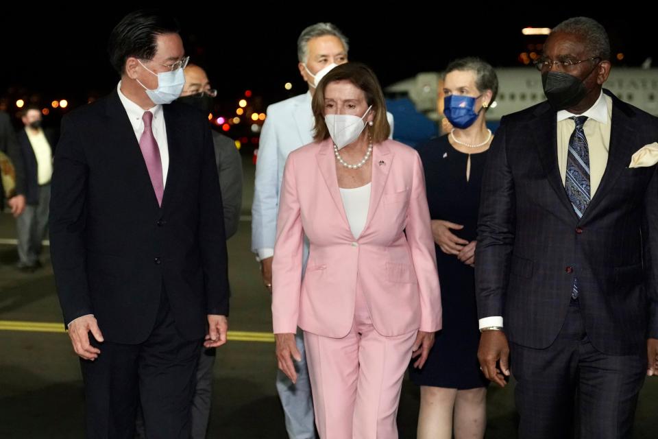 Then-Speaker Nancy Pelosi, center, arrives in Taipei, Taiwan, on Aug. 2 despite threats from Beijing of serious consequences, becoming the highest-ranking American official to visit the self-ruled island claimed by China in 25 years