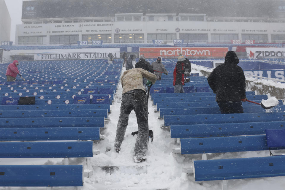 Workers remove snow from Highmark Stadium in Orchard Park, N.Y., Sunday Jan. 14, 2024. A potentially dangerous snowstorm that hit the Buffalo region on Saturday led the NFL to push back the Bills wild-card playoff game against the Pittsburgh Steelers from Sunday to Monday. New York Gov. Kathy Hochul and the NFL cited public safety concerns for the postponement, with up to 2 feet of snow projected to fall on the region over a 24- plus hour period. (AP Photo/ Jeffrey T. Barnes)