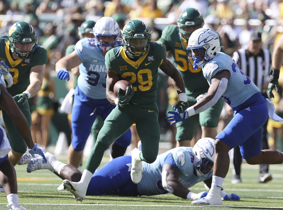FILE - Baylor running back Richard Reese runs through the Kansas defense in the first half of an NCAA college football game, Saturday, Oct. 22, 2022, in Waco, Texas. Baylor and Air Force will play in the Armed Forced Bowl on Dec. 22 in Fort Worth, Texas.(AP Photo/Jerry Larson, File)
