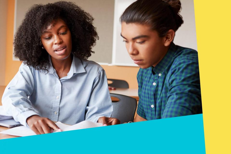 An image of a woman helping a teen with schoolwork.