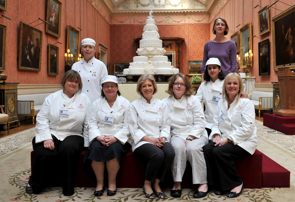 Fiona Cairns and her team pose for a photograph with the Royal Wedding cake that was made for Prince William and Kate Middleton   (Photo by John Stillwell/PA Images via Getty Images)