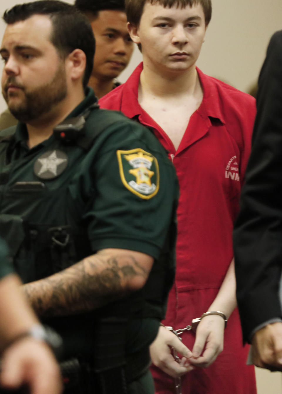 Aiden Fucci is led into the courtroom start his sentencing hearing, Friday, March 24, 2023. in St. Augustine, Fla. A Florida judge sentenced the 16-year-old Florida boy to life in prison on Friday for fatally stabbing a 13-year-old classmate on Mother's Day in 2021. Fucci, who pleaded guilty just before his trial was set to start in February, was not eligible for the death penalty. (Bob Self/The Florida Times-Union via AP)