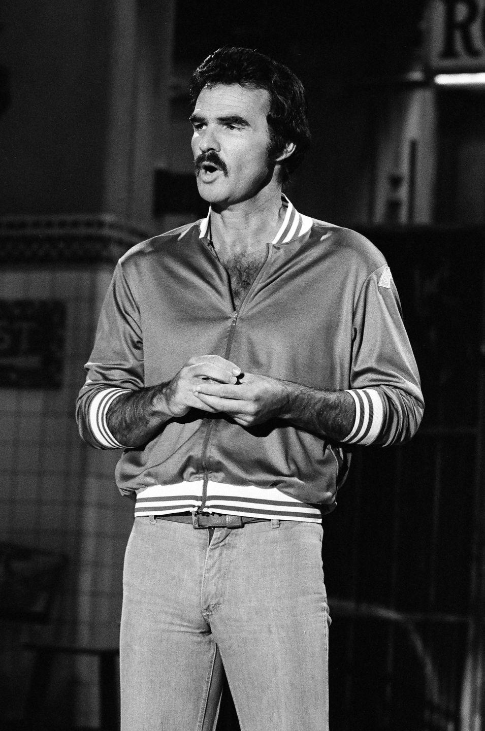 <p>Reynolds in a vinyl jacket—and nothing else on top?—hosts <em>Saturday Night Live</em> on April 12, 1980. </p>