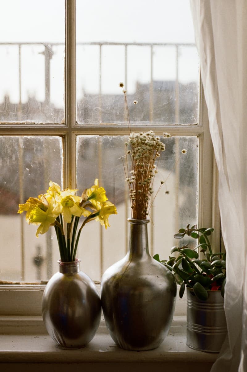 Metallic vases on a window sill.