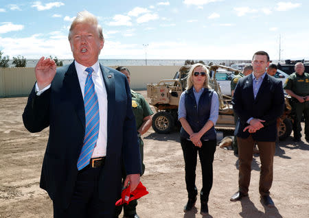 FILE PHOTO: Homeland Security Secretary Kirstjen Nielsen and commissioner for Customs and Border Patrol Kevin McAleenan listen to U.S. President Donald Trump speak during a visit to a section of border wall in Calexico California, U.S., April 5, 2019. Picture taken April 5, 2019. REUTERS/Kevin Lamarque