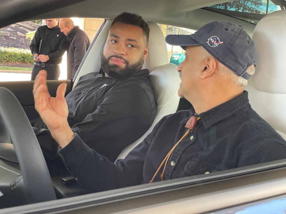 Tesla Operations Advisor Pedro Villegas talks with Glastonbury resident Mehrdad Faezi about his new Tesla Model 3. Faezi was one of the first customers of the new Tesla showroom and sales and delivery center at Mohegan Sun.