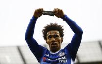 Britain Football Soccer - Manchester City v Chelsea - Premier League - Etihad Stadium - 3/12/16 Chelsea's Willian celebrates scoring their second goal holds a armband in respect for the victims of the Colombia plane crash containing the Chapecoense players and staff Action Images via Reuters / Jason Cairnduff Livepic EDITORIAL USE ONLY. No use with unauthorized audio, video, data, fixture lists, club/league logos or "live" services. Online in-match use limited to 45 images, no video emulation. No use in betting, games or single club/league/player publications. Please contact your account representative for further details.