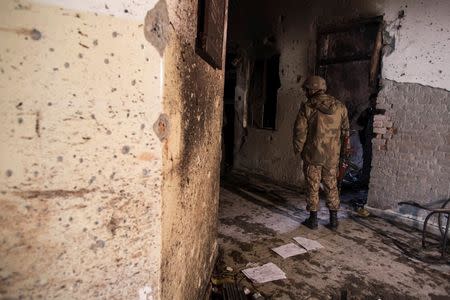 An army soldier stands in the Army Public School, which was attacked by Taliban gunmen, in Peshawar, December 17, 2014. REUTERS/Zohra Bensemra