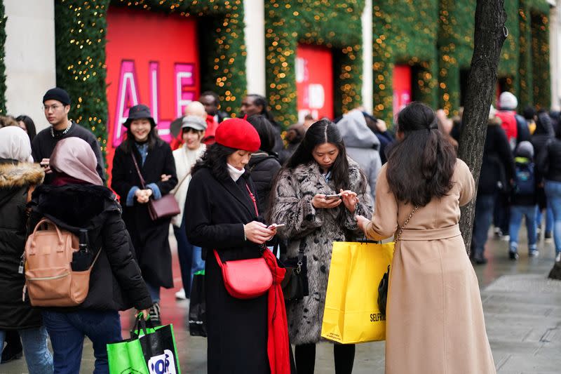 Shoppers stand on Oxford Street during Boxing Day sales in central London