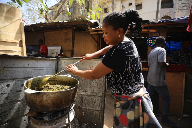 A woman prepares vegetable soup for lunch in Abuja