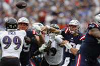 New England Patriots quarterback Mac Jones (10) passes under pressure from Baltimore Ravens linebacker Odafe Oweh (99) in the first half of an NFL football game, Sunday, Sept. 25, 2022, in Foxborough, Mass. (AP Photo/Michael Dwyer)