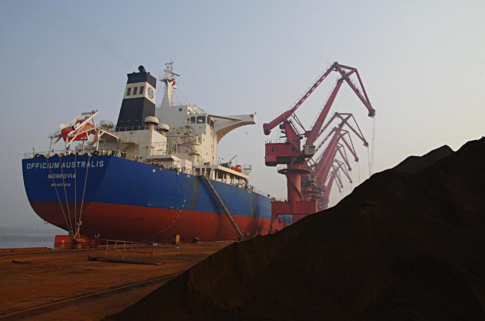 In this photo taken Thursday, May 1, 2014, cranes unload imported iron ore from a ship at a port in Rizhao in east China's Shandong province. China's trade rebounded in April from the previous month's surprise contraction but imports were subdued in another sign of the country's economic slowdown. Customs data Thursday, May 8, 2014 showed exports rose 0.9 percent, recovering from March's 6.6 percent decline. Imports rose 0.8 percent, up from the previous month's 11.3 percent decline. (AP Photo) CHINA OUT