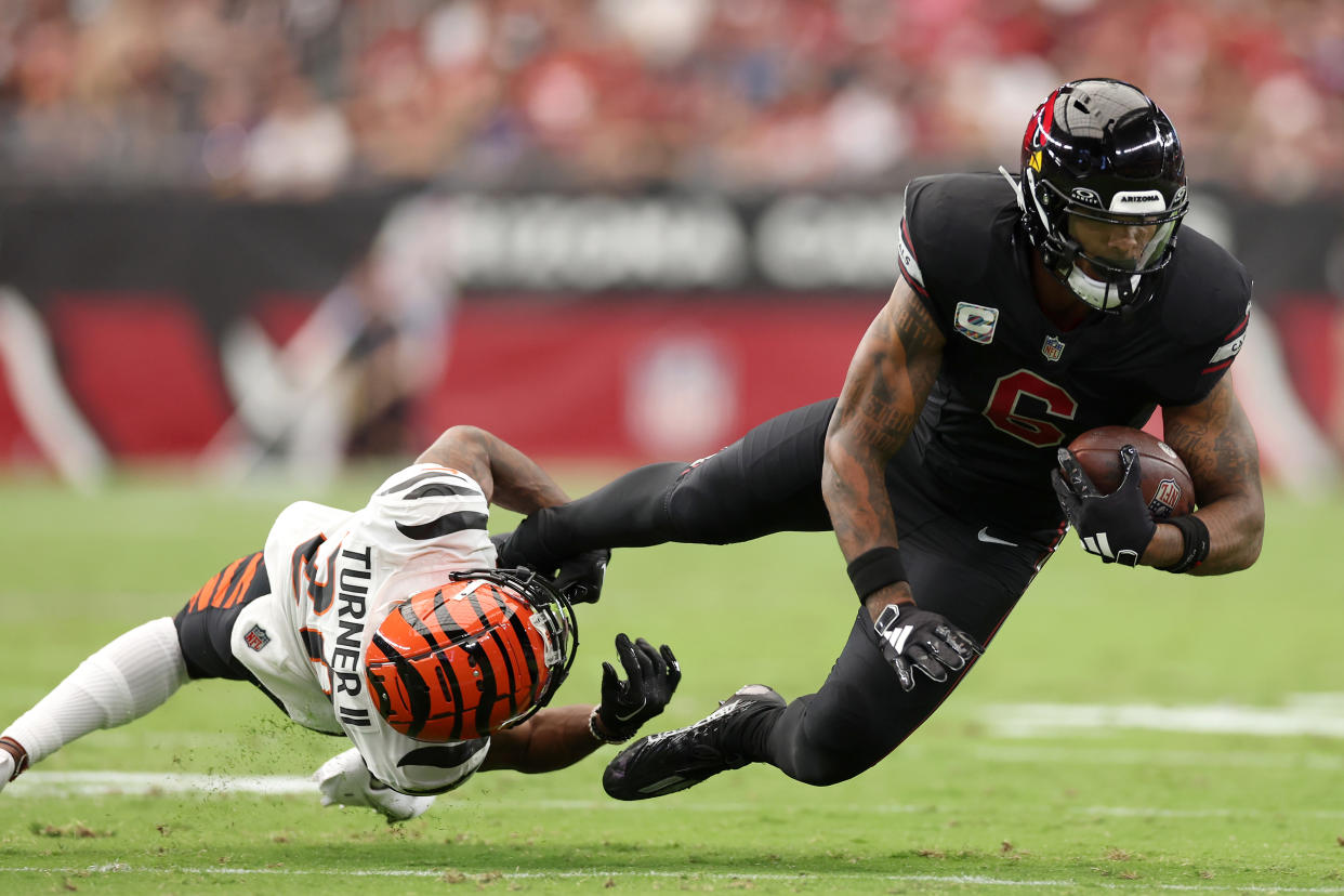 GLENDALE, ARIZONA - OCTOBER 08: DJ Turner II #20 of the Cincinnati Bengals tackles James Conner #6 of the Arizona Cardinals during the second quarter at State Farm Stadium on October 08, 2023 in Glendale, Arizona. (Photo by Christian Petersen/Getty Images)