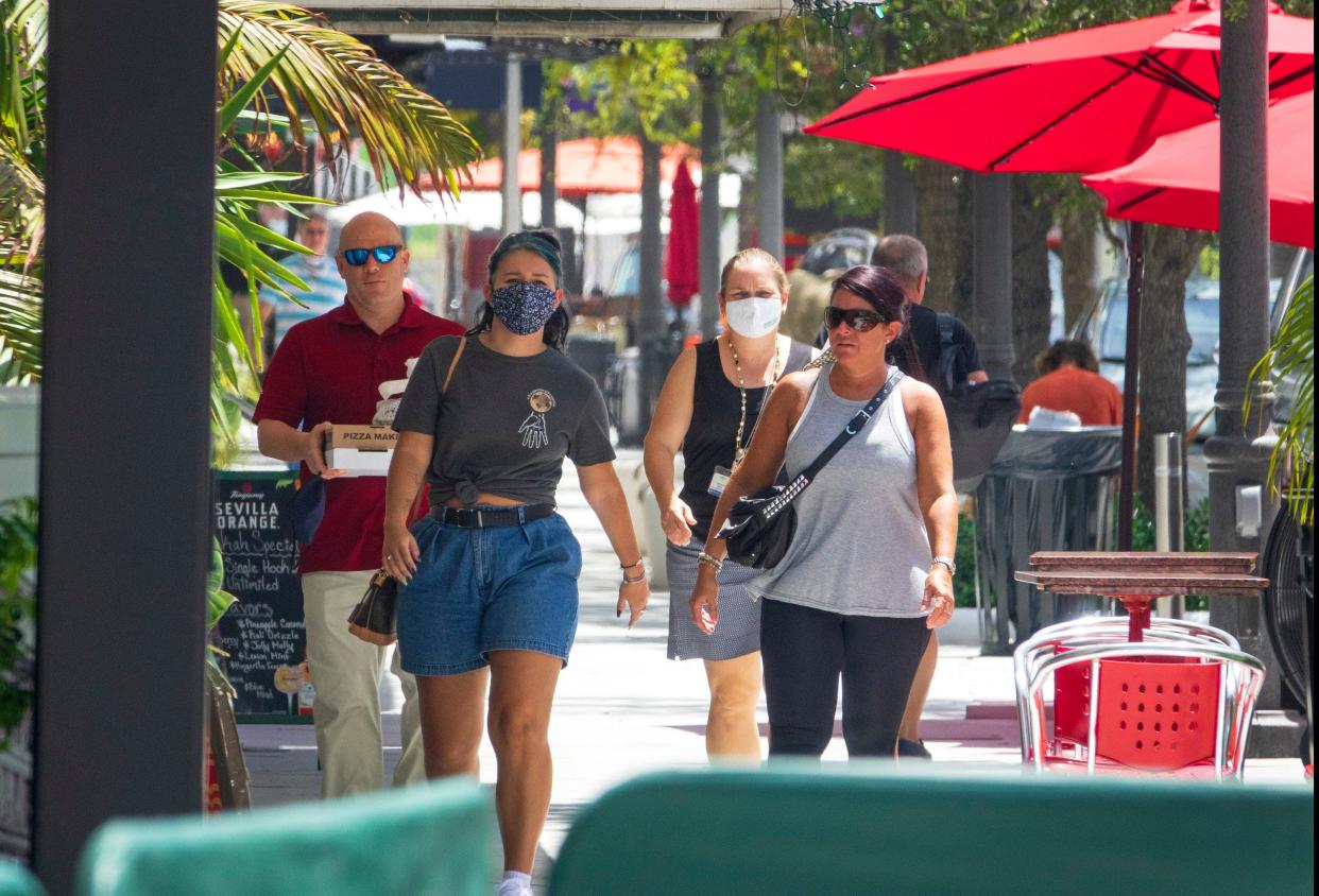 People shown walking down the 300 block of Clematis Street in downtown West Palm Beach. The Clematis Streetscape project continues to draw residents and tourists. [LANNIS WATERS/palmbeachpost.com]