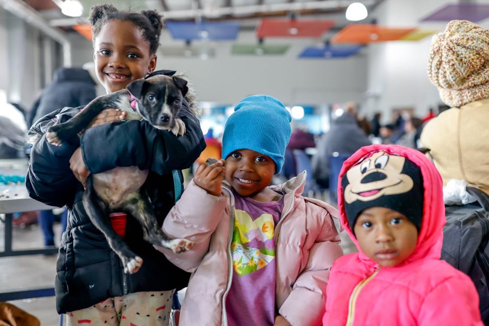 Amerie Harris, Amiaa Tezeno, Alani Harris and their dog Dutchess wait with their mother on Jan. 13 at the Homeless Alliance day shelter in Oklahoma City.