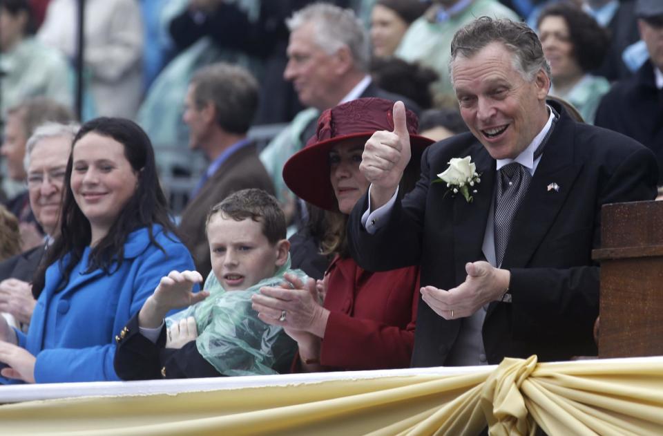 Virginia Governor Terry McAuliffe, right, gives thumbs up as he and his wife Dorothy, second from right, son, Peter and daughter, Sally, left, watch the members of an Indian dance troupe as they perform during inaugural ceremonies at the Capitol in Richmond, Va., Saturday, Jan. 11, 2014. McAuliffe was sworn in Saturday as the 72nd Governor of Virginia. (AP Photo/Steve Helber)