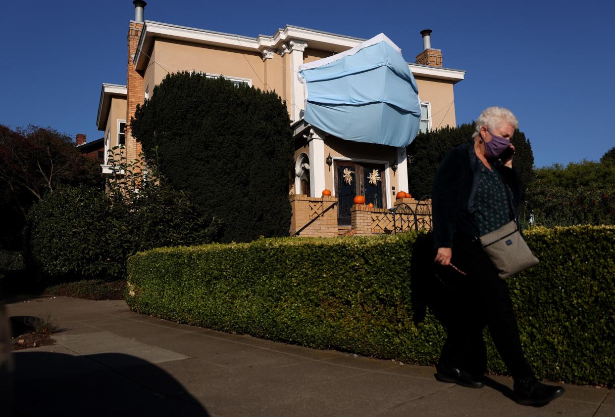 A large custom made surgical mask is displayed on the front of a home on Oct. 23, 2020 in San Francisco, California.