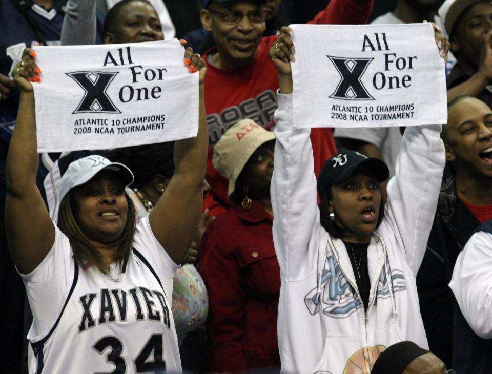 MARCH 22, 2008: Xavier's Stanley Burrell's aunt Ronda Randall, left, and his mother Wonda Burrell cheer after beating Purdue on March 22, 2008 at the Verizon Center in Washington D.C.