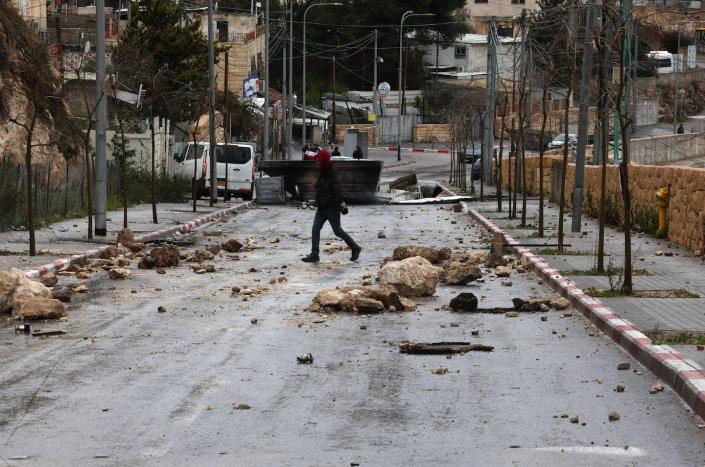 Palestinians block roads to protest home demolition <a href="https://www.gettyimages.com/detail/news-photo/palestinian-man-crosses-a-blocked-street-during-a-strike-news-photo/1246688007?phrase=East{e421c4d081ed1e1efd2d9b9e397159b409f6f1af1639f2363bfecd2822ec732a}20jerusalem{e421c4d081ed1e1efd2d9b9e397159b409f6f1af1639f2363bfecd2822ec732a}20palestinian{e421c4d081ed1e1efd2d9b9e397159b409f6f1af1639f2363bfecd2822ec732a}20home&adppopup=true" rel="nofollow noopener" target="_blank" data-ylk="slk:Ahmad Gharabli/AFP via Getty Images)" class="link ">Ahmad Gharabli/AFP via Getty Images)</a>