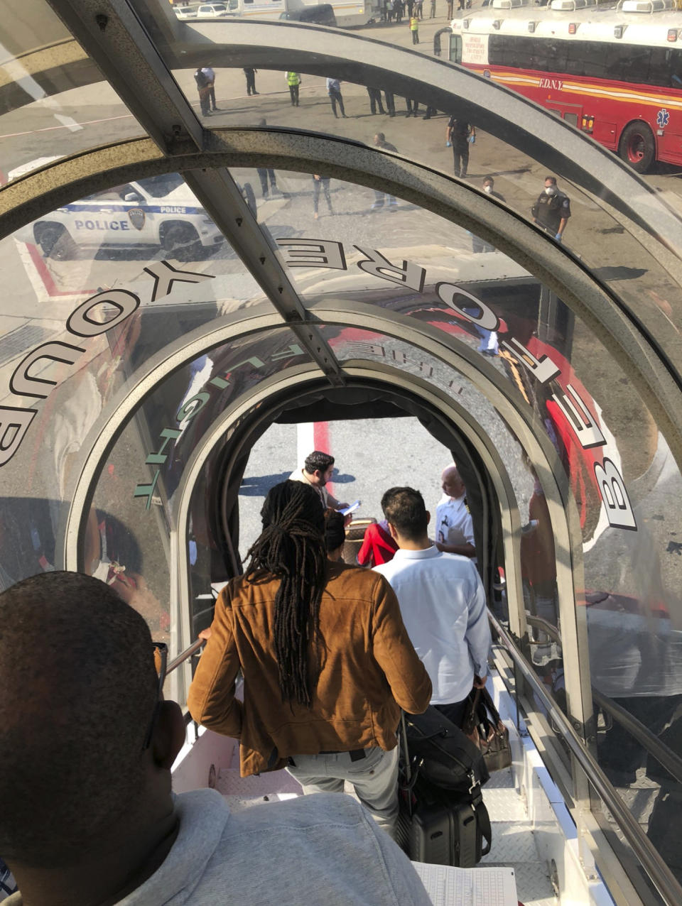 Passengers leave an Emirates airplane at New York's Kennedy Airport amid reports of ill passengers aboard a flight from Dubai on Wednesday, Sept. 5, 2018. (Larry Coben via AP)